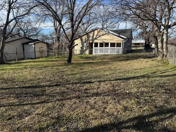 a front view of house with trees