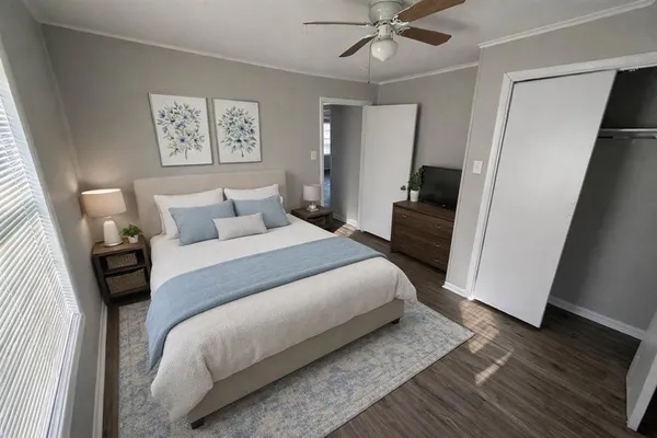 a bedroom with a bed and a large mirror