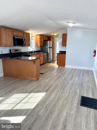 a kitchen with stainless steel appliances kitchen island granite countertop a stove a sink and a microwave