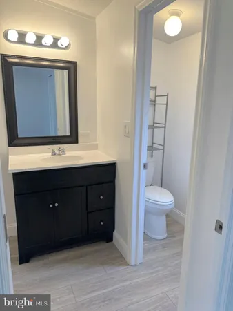 a bathroom with a toilet sink and mirror