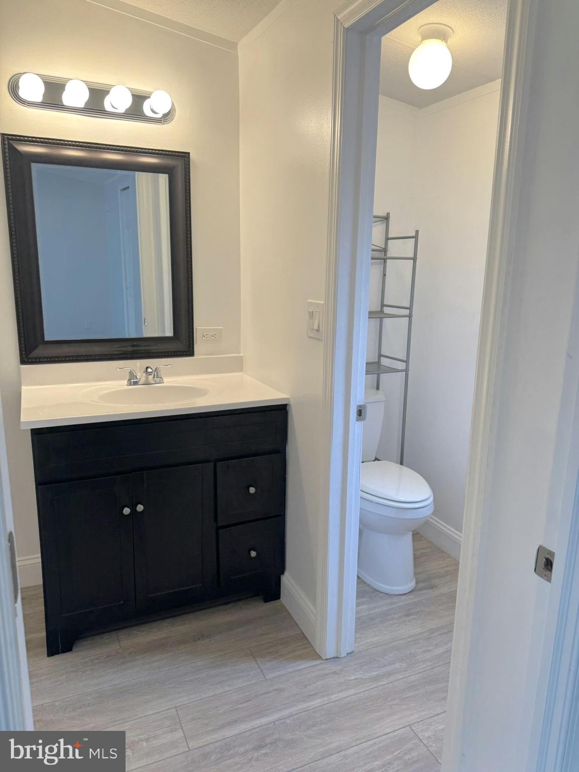 1616 North Main Street Williamstown, NJ 08094 - Photo 18 of 39 a bathroom with a toilet sink and mirror