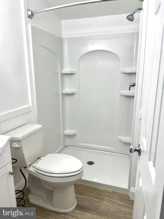 a bathroom with a toilet and a shower
