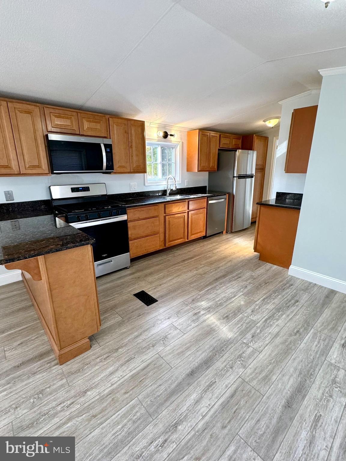1616 North Main Street Williamstown, NJ 08094 - Photo 9 of 39 a large kitchen with stainless steel appliances wooden floors and a counter space
