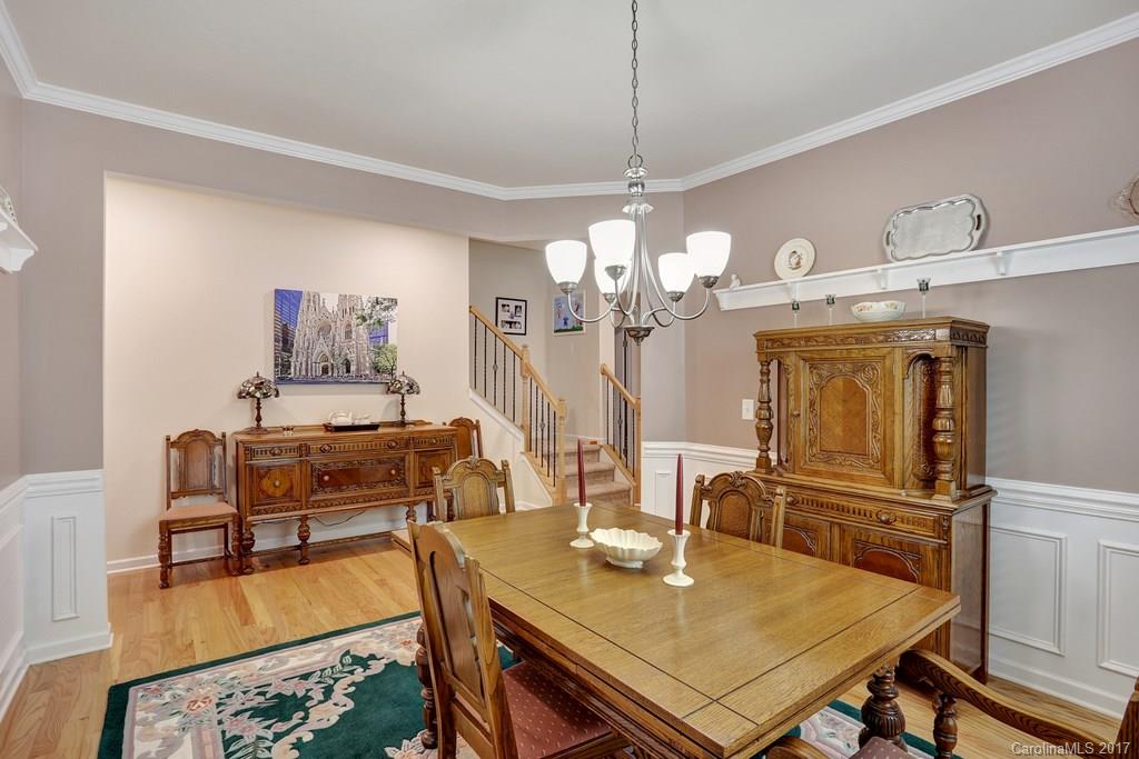 4135 Perth Road, Unit 374 Indian Land, SC 29707 - Photo 11 of 24 a view of a dining room with furniture a chandelier and wooden floor
