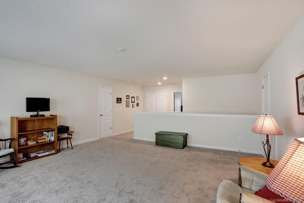4135 Perth Road, Unit 374 Indian Land, SC 29707 - Photo 19 of 24 a living room with furniture and a lamp