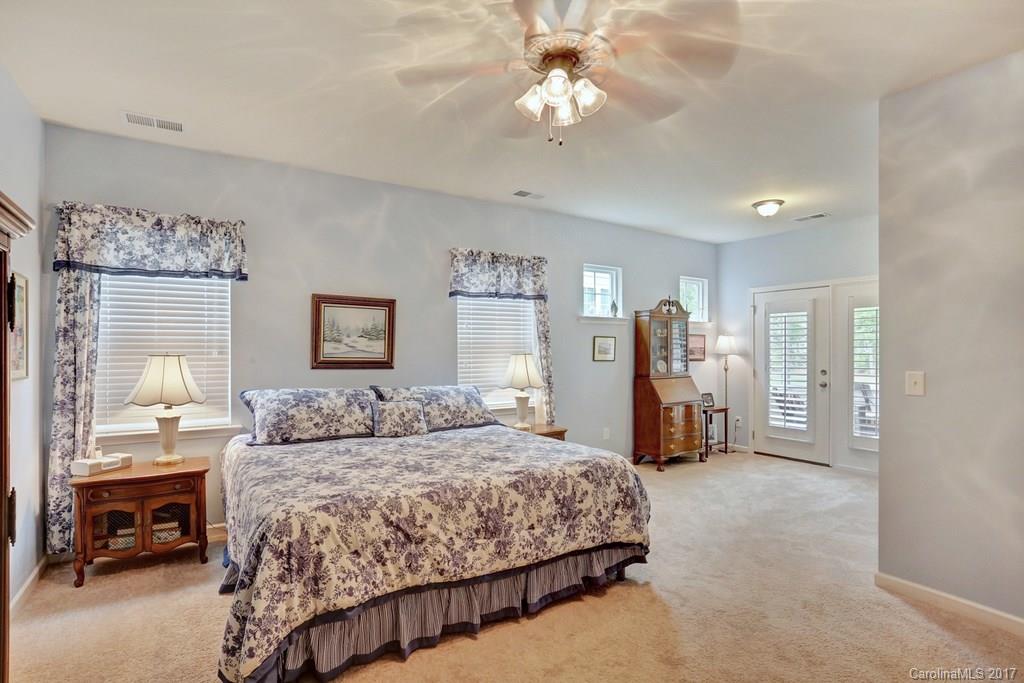 4135 Perth Road, Unit 374 Indian Land, SC 29707 - Photo 22 of 24 a bedroom with a bed and a chandelier