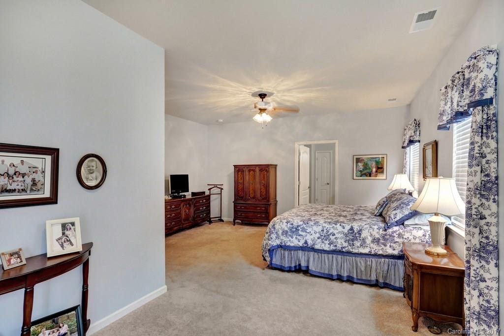 4135 Perth Road, Unit 374 Indian Land, SC 29707 - Photo 23 of 24 a bedroom with a bed and a chandelier