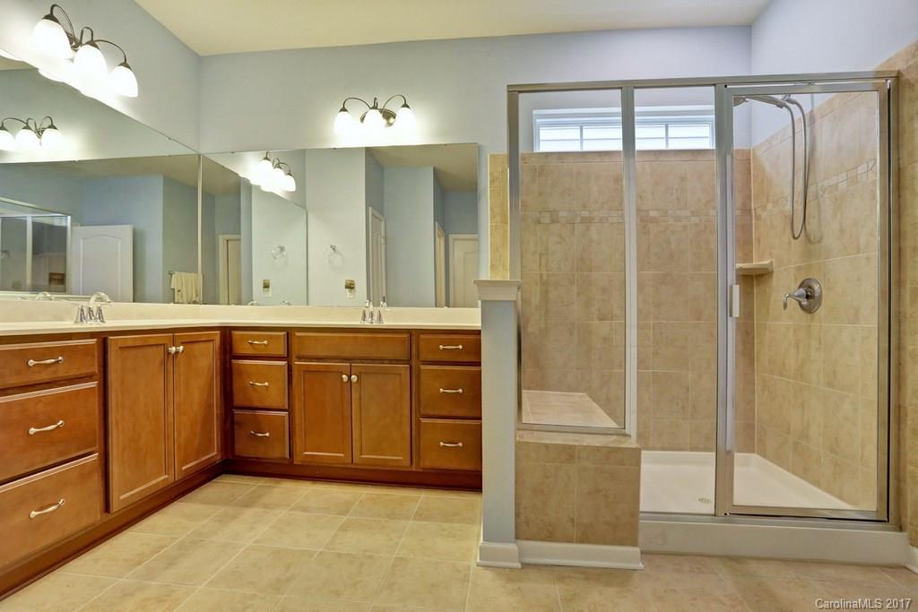 4135 Perth Road, Unit 374 Indian Land, SC 29707 - Photo 24 of 24 a bathroom with a granite countertop sink mirror and shower