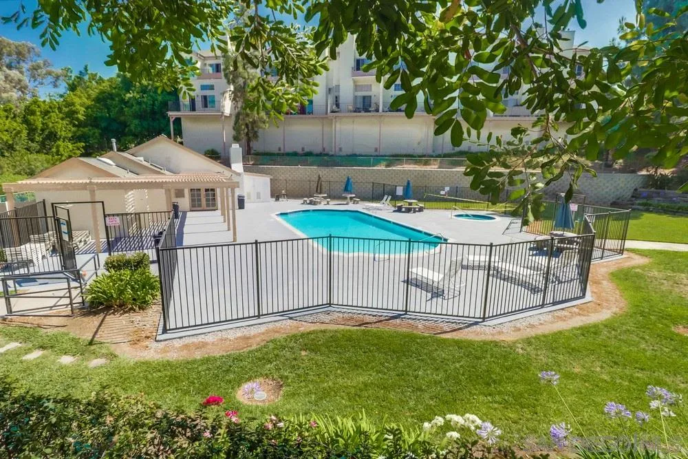 8701 Spring Canyon Drive Spring Valley, CA 91977 - Photo 22 of 24 a white house with a big yard and large trees