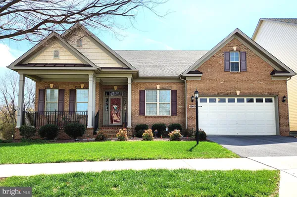 a front view of a house with a garden and plants