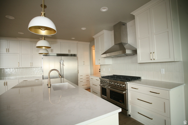 635 East Mountain Road North Ogden, UT 84414 - Photo 5 of 33 Expansive kitchen featuring white cabinetry, light-toned countertops, and two-tone pendant lighting