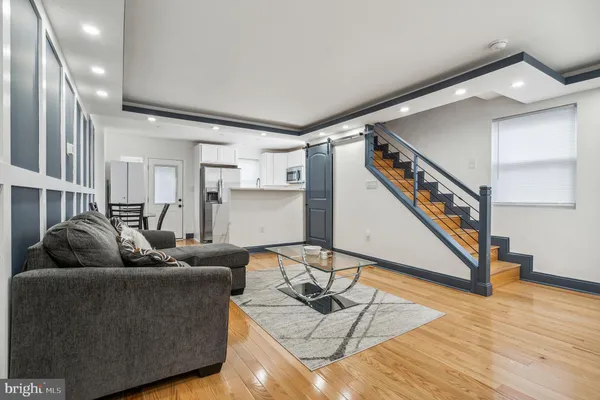 a living room with furniture and wooden floor