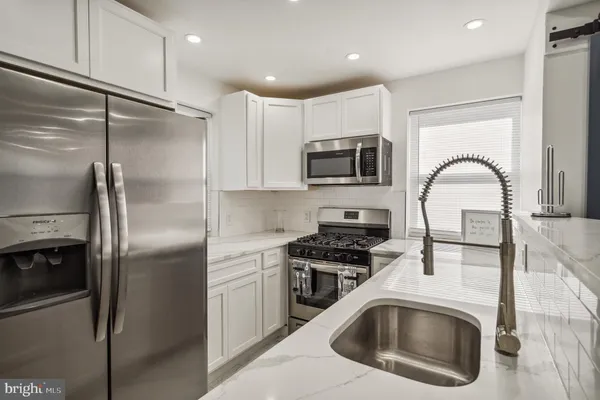 a kitchen with a refrigerator sink and stove