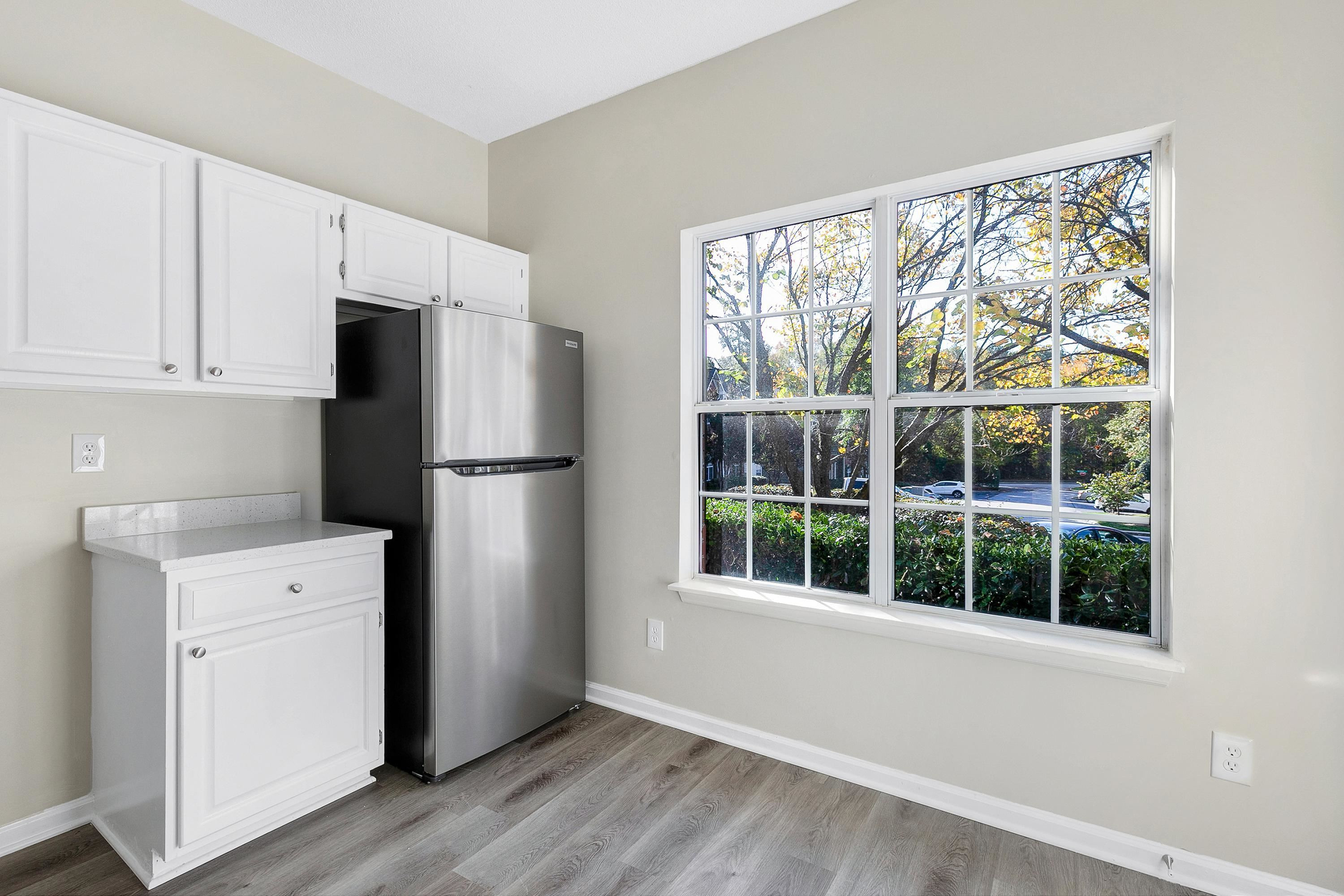 4424 Still Pines Drive Raleigh, NC 27613 - Photo 11 of 34 a kitchen with a refrigerator and wooden floor