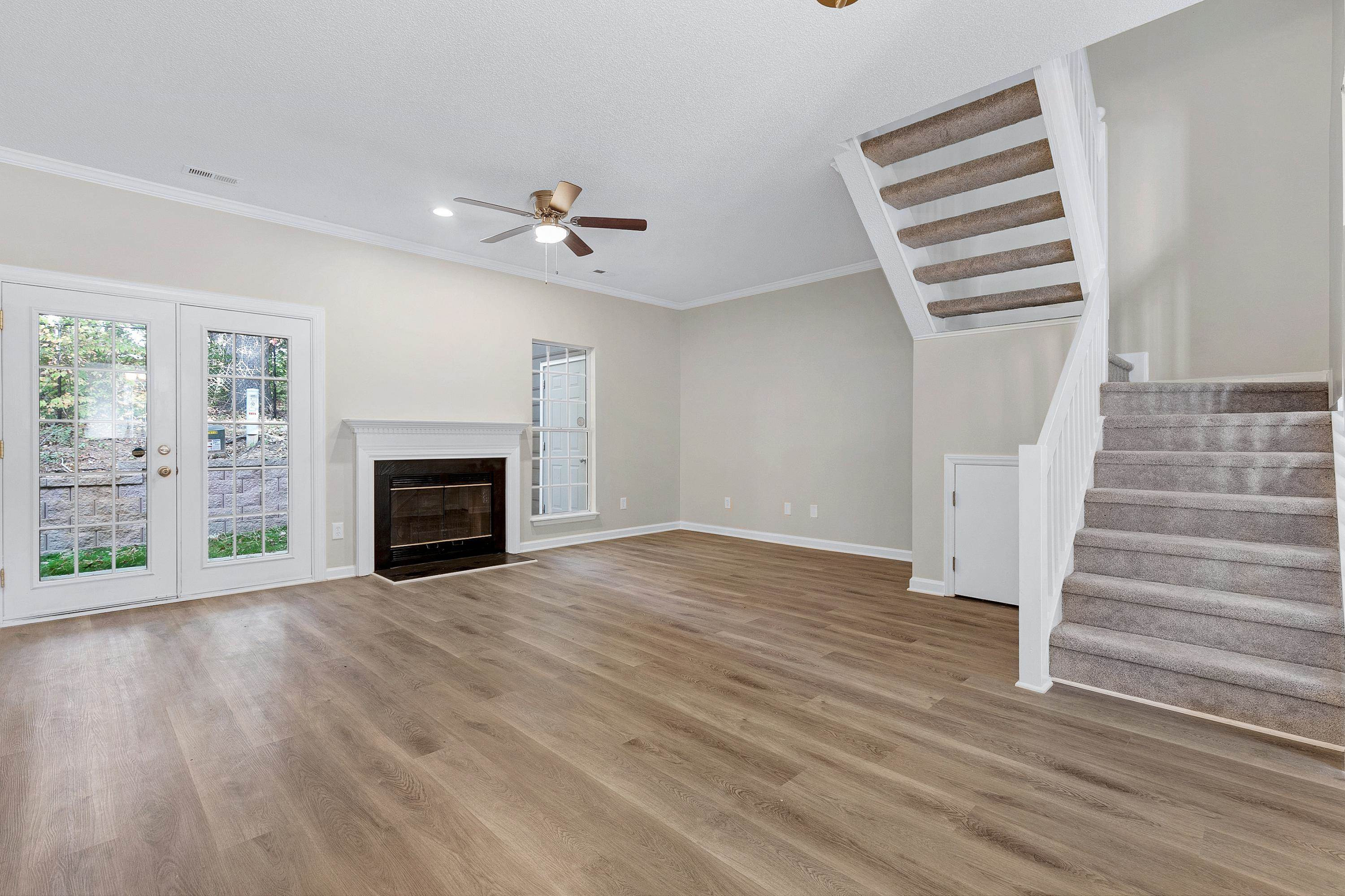 4424 Still Pines Drive Raleigh, NC 27613 - Photo 12 of 34 an empty room with windows and fireplace
