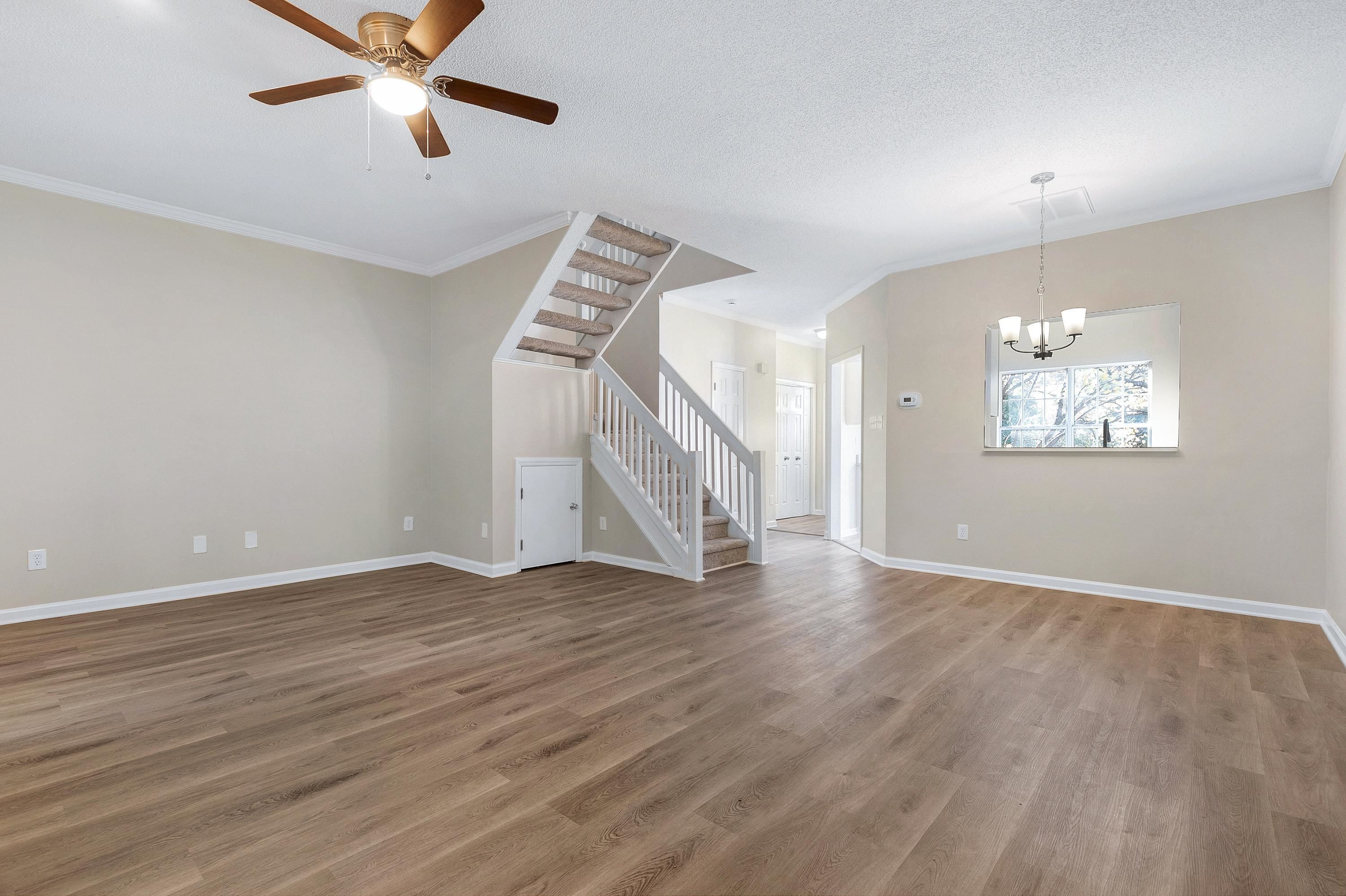 4424 Still Pines Drive Raleigh, NC 27613 - Photo 13 of 34 a view of an empty room with wooden floor and a ceiling fan