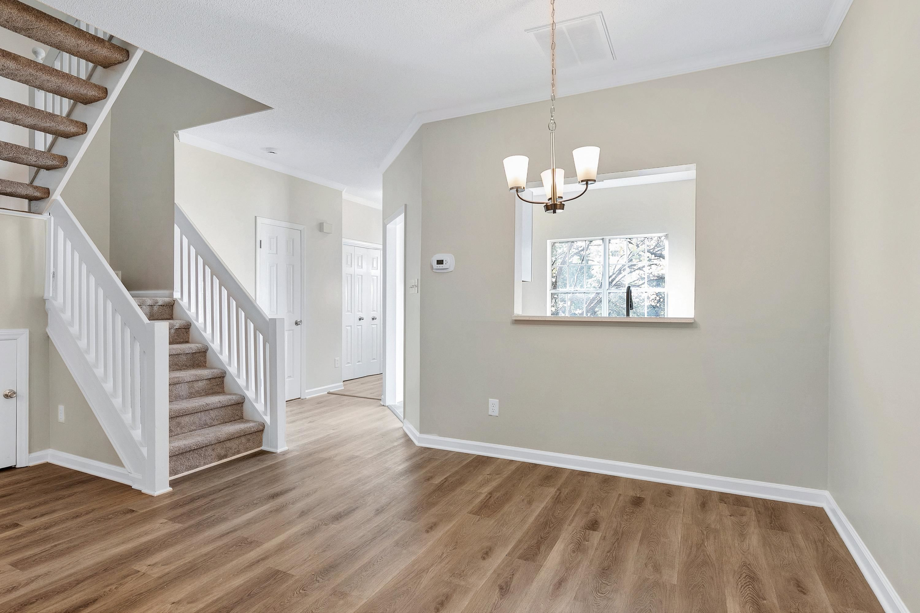 4424 Still Pines Drive Raleigh, NC 27613 - Photo 14 of 34 a view of a room with wooden floor chandelier and entryway
