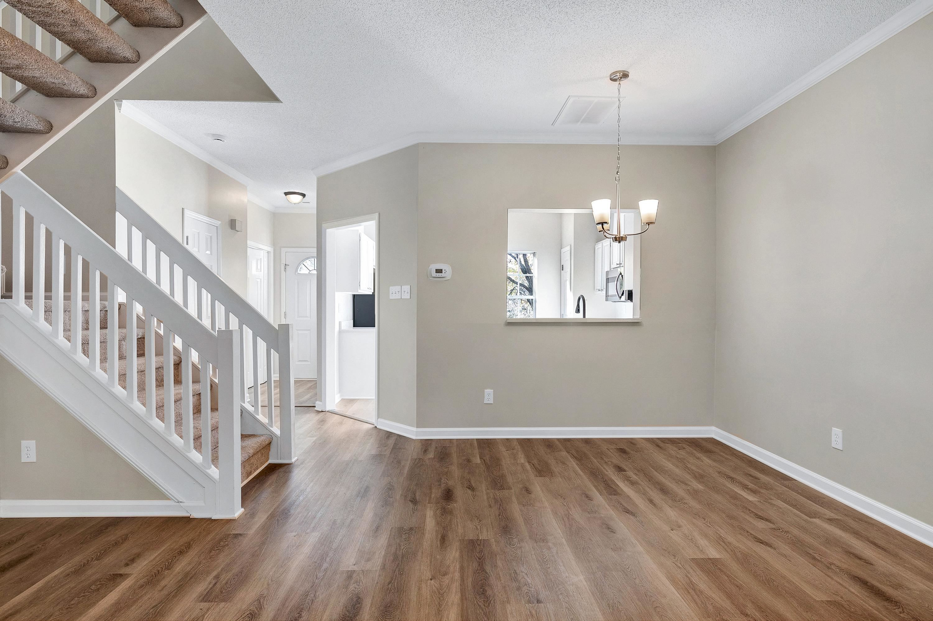 4424 Still Pines Drive Raleigh, NC 27613 - Photo 15 of 34 wooden floor in an empty room with a window