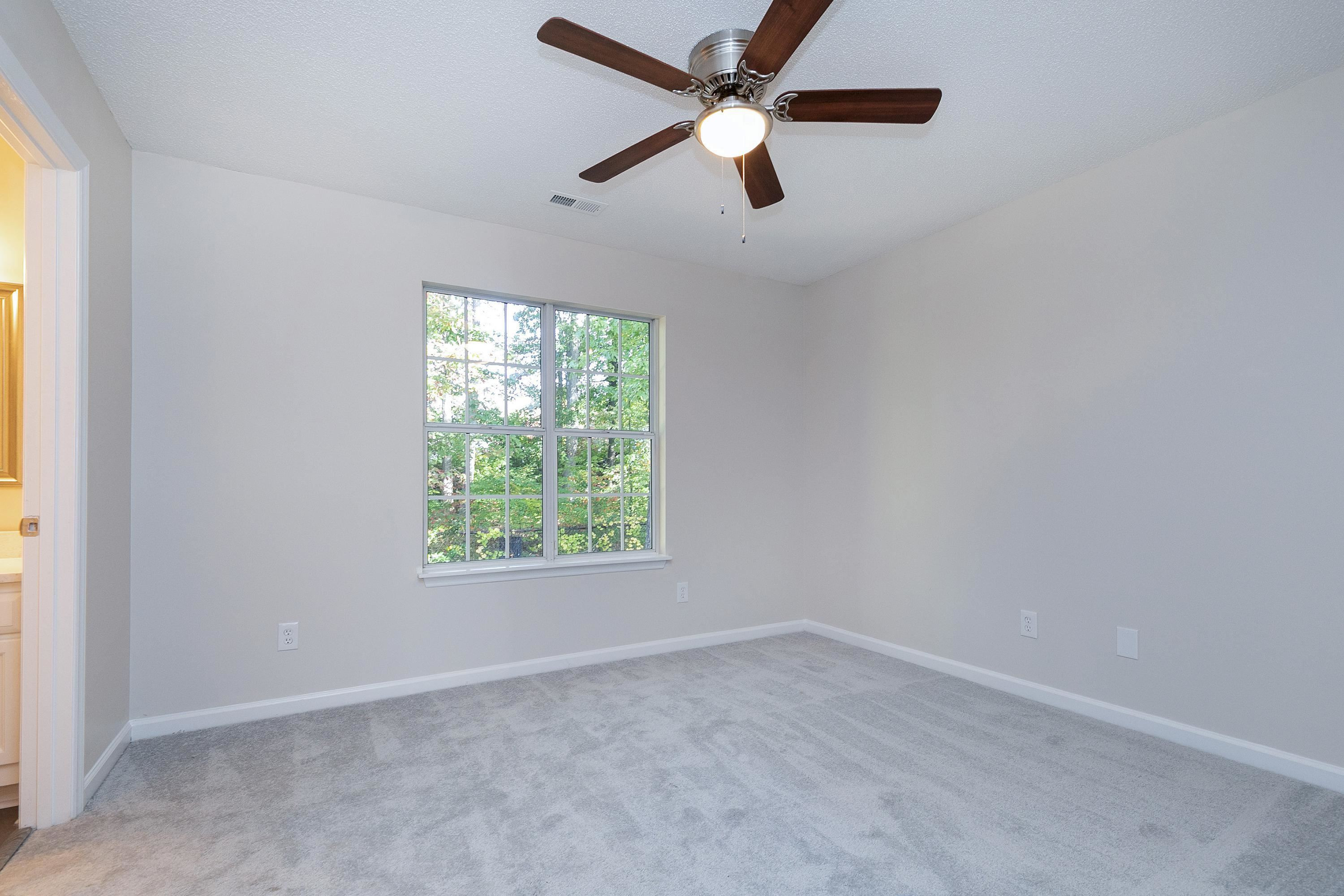4424 Still Pines Drive Raleigh, NC 27613 - Photo 23 of 34 an empty room with a window and a fan