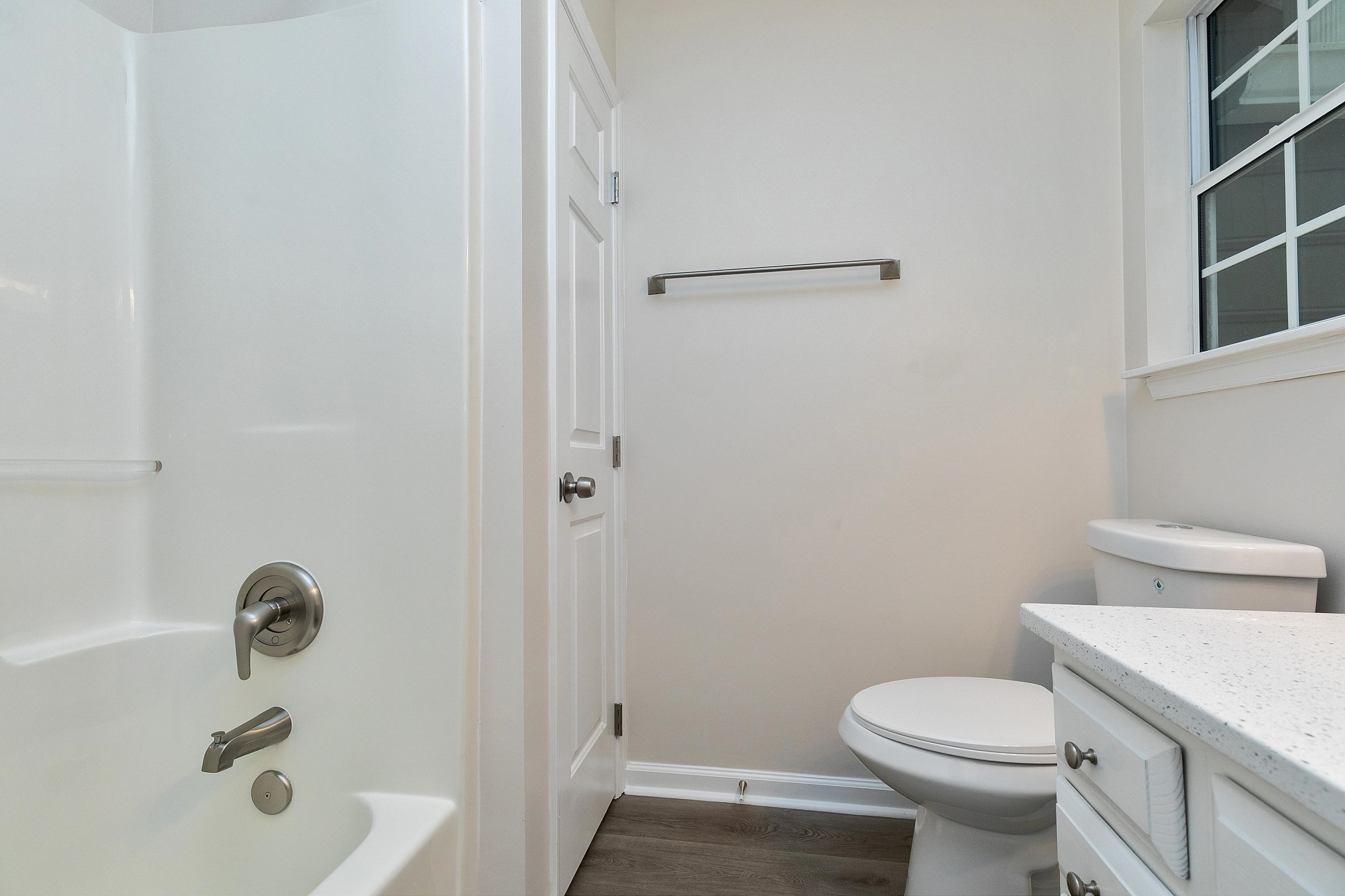 4424 Still Pines Drive Raleigh, NC 27613 - Photo 26 of 34 a white toilet sitting next to a bath tub