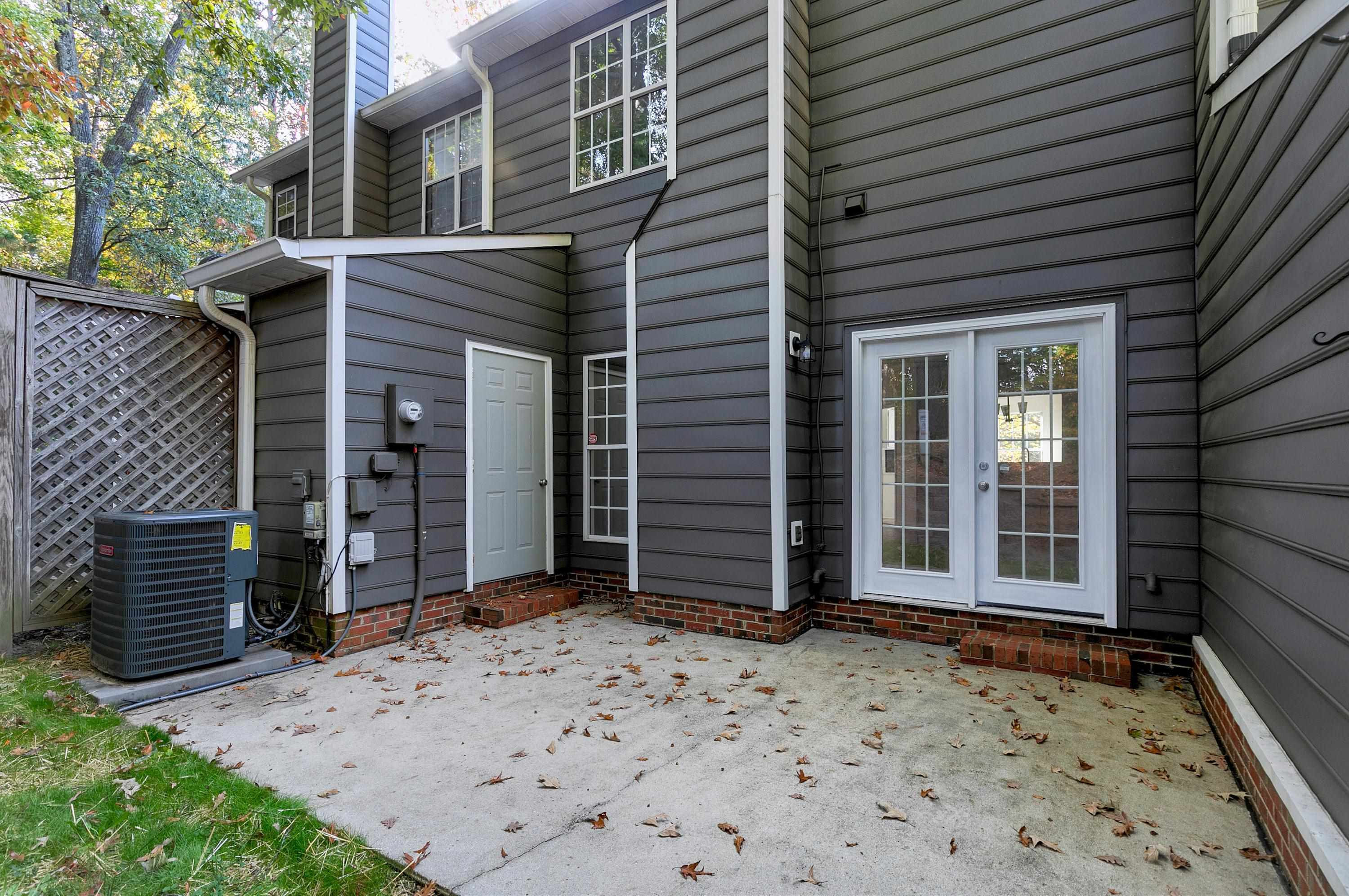 4424 Still Pines Drive Raleigh, NC 27613 - Photo 34 of 34 a view of a house with wooden door and a outdoor space