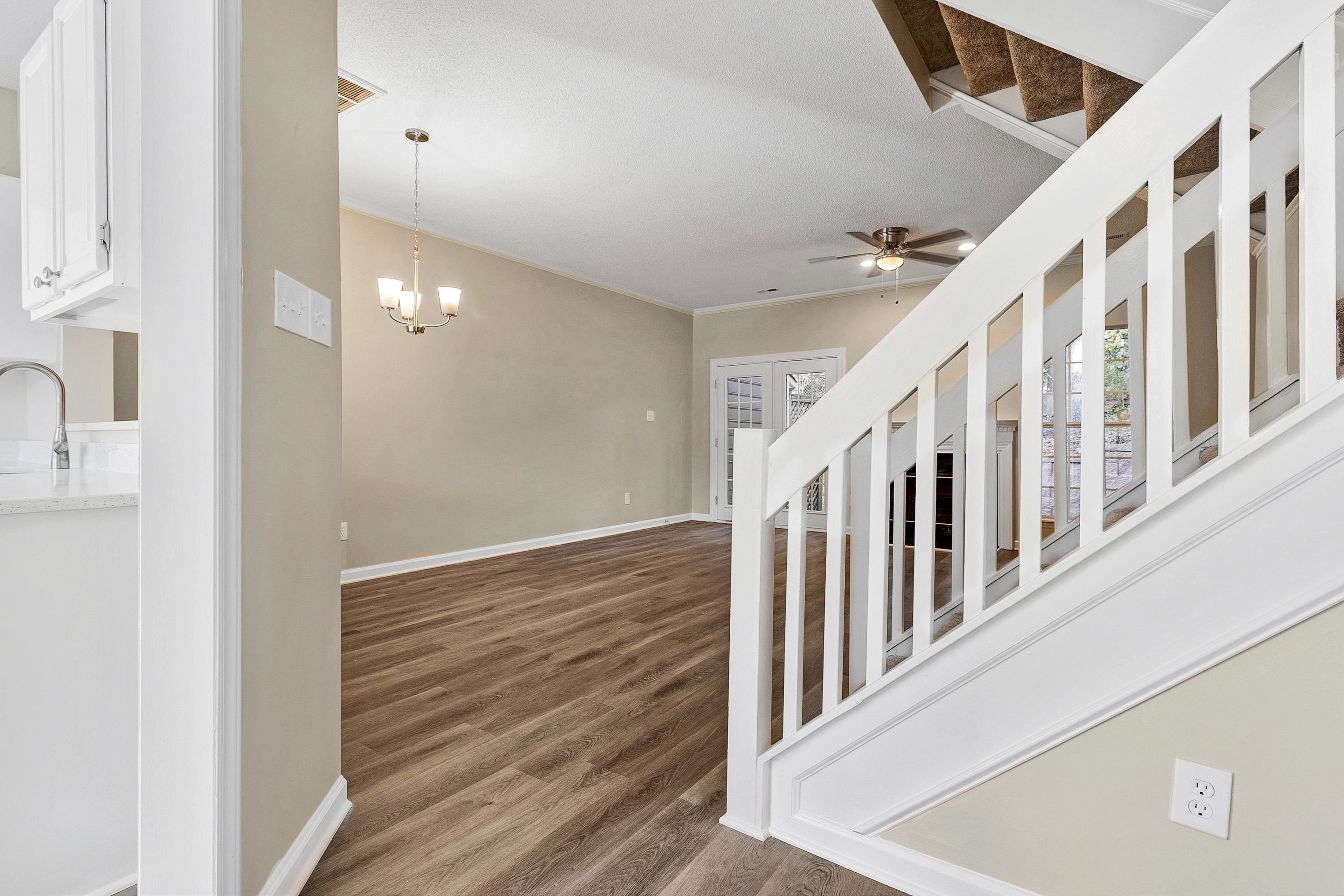 4424 Still Pines Drive Raleigh, NC 27613 - Photo 4 of 34 a view of staircase with lots of frames on wall and a large window