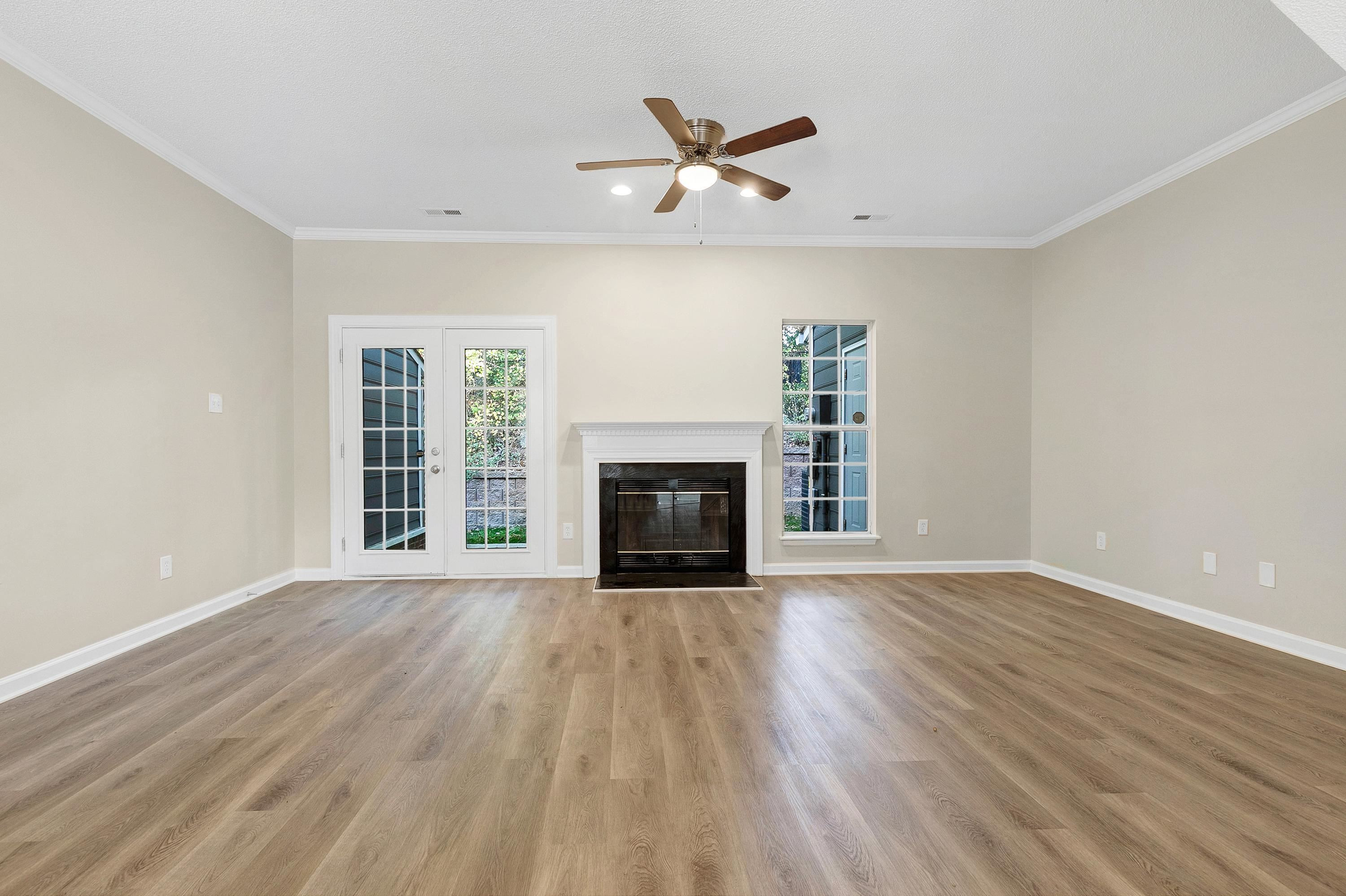 4424 Still Pines Drive Raleigh, NC 27613 - Photo 10 of 34 an empty room with windows a fireplace