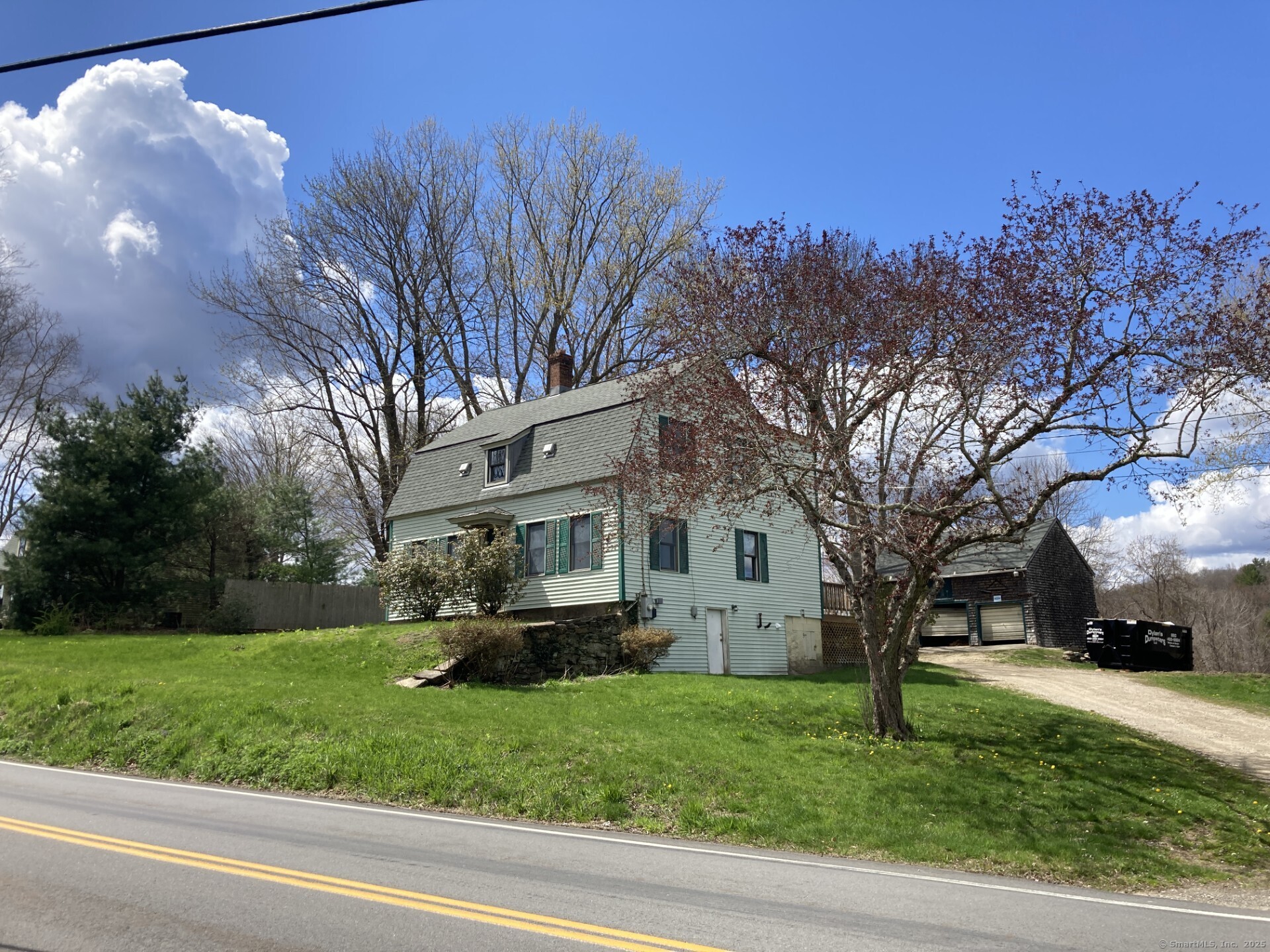 a view of house with yard and green space