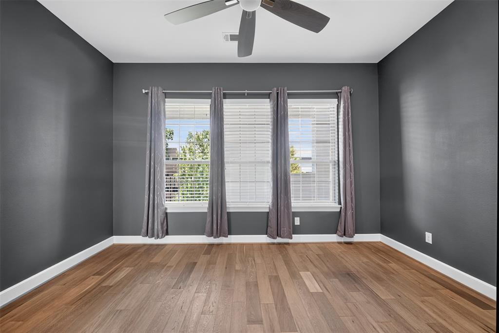 5015 Meridian Lane, Unit 2102 Addison, TX 75001 - Photo 18 of 36 Room with wood-finish flooring, dark gray walls, and white baseboards