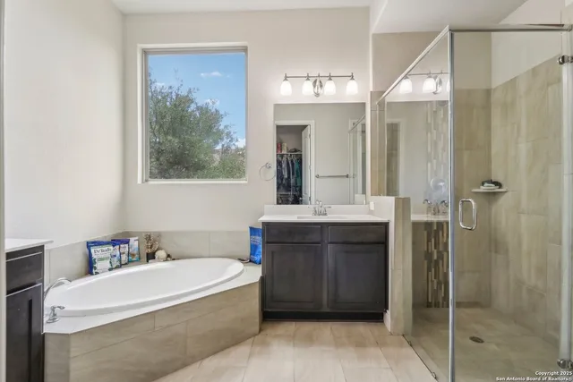 a bathroom with a tub a sink and mirrors