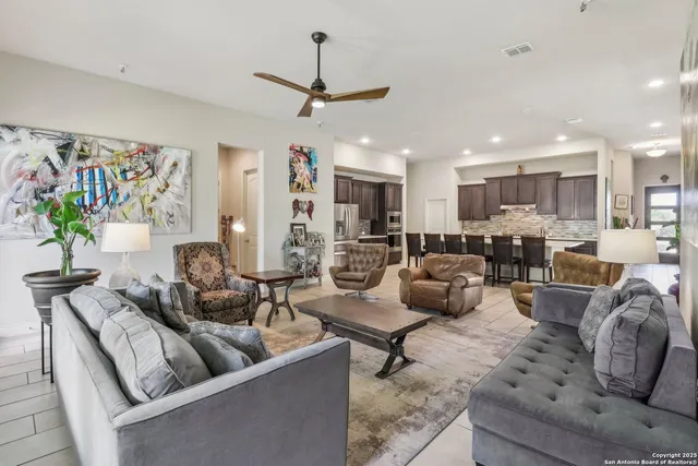 a living room with furniture kitchen area and a couch
