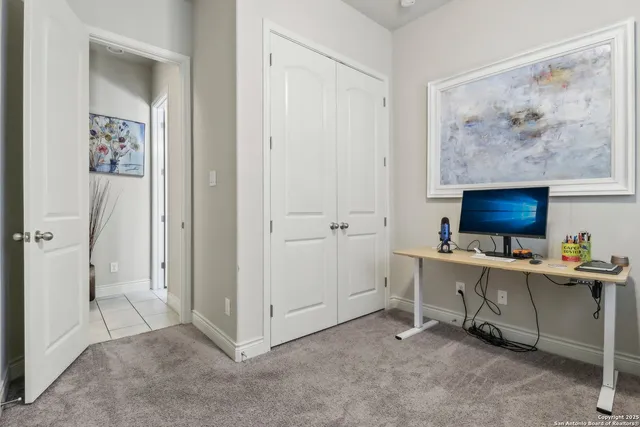 a view of a workspace with furniture and a workspace