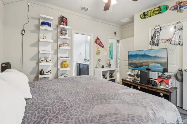 a bedroom with a bed dresser and a large window