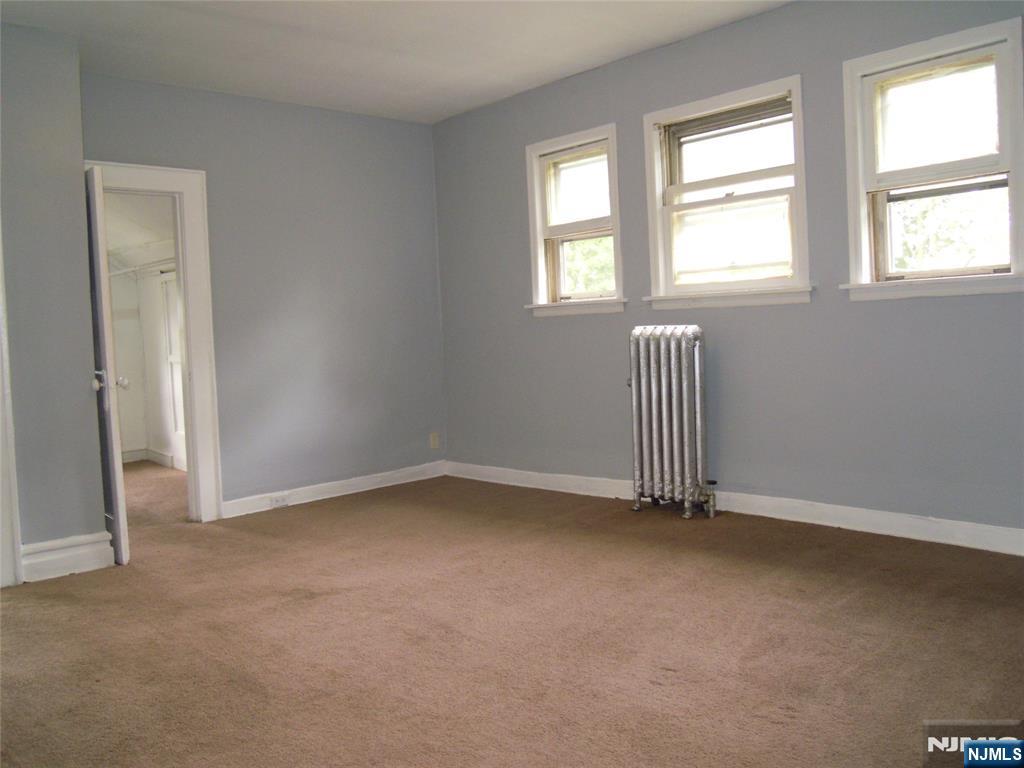 56-58 Pine Grove Terrace, Unit UPPR Newark, NJ 07106 - Photo 6 of 7 an empty room with a window