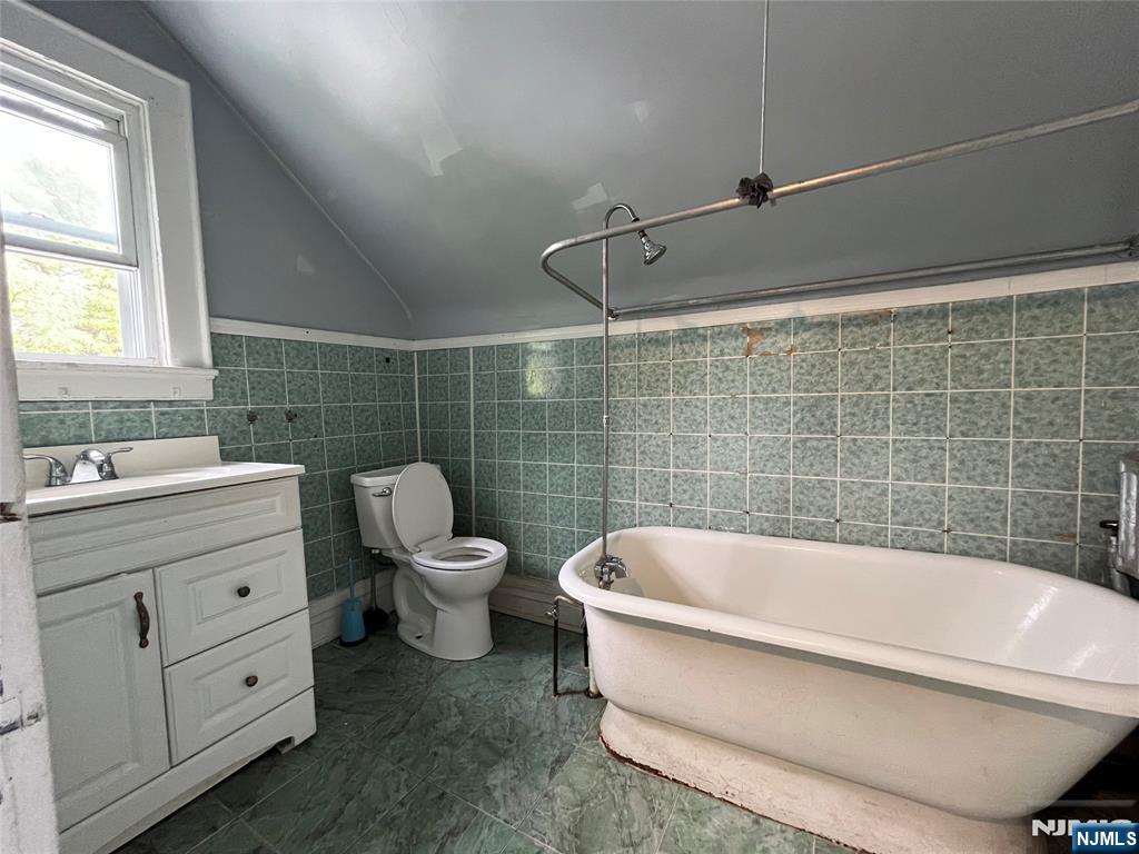 56-58 Pine Grove Terrace, Unit UPPR Newark, NJ 07106 - Photo 7 of 7 a bathroom with a bathtub and sink