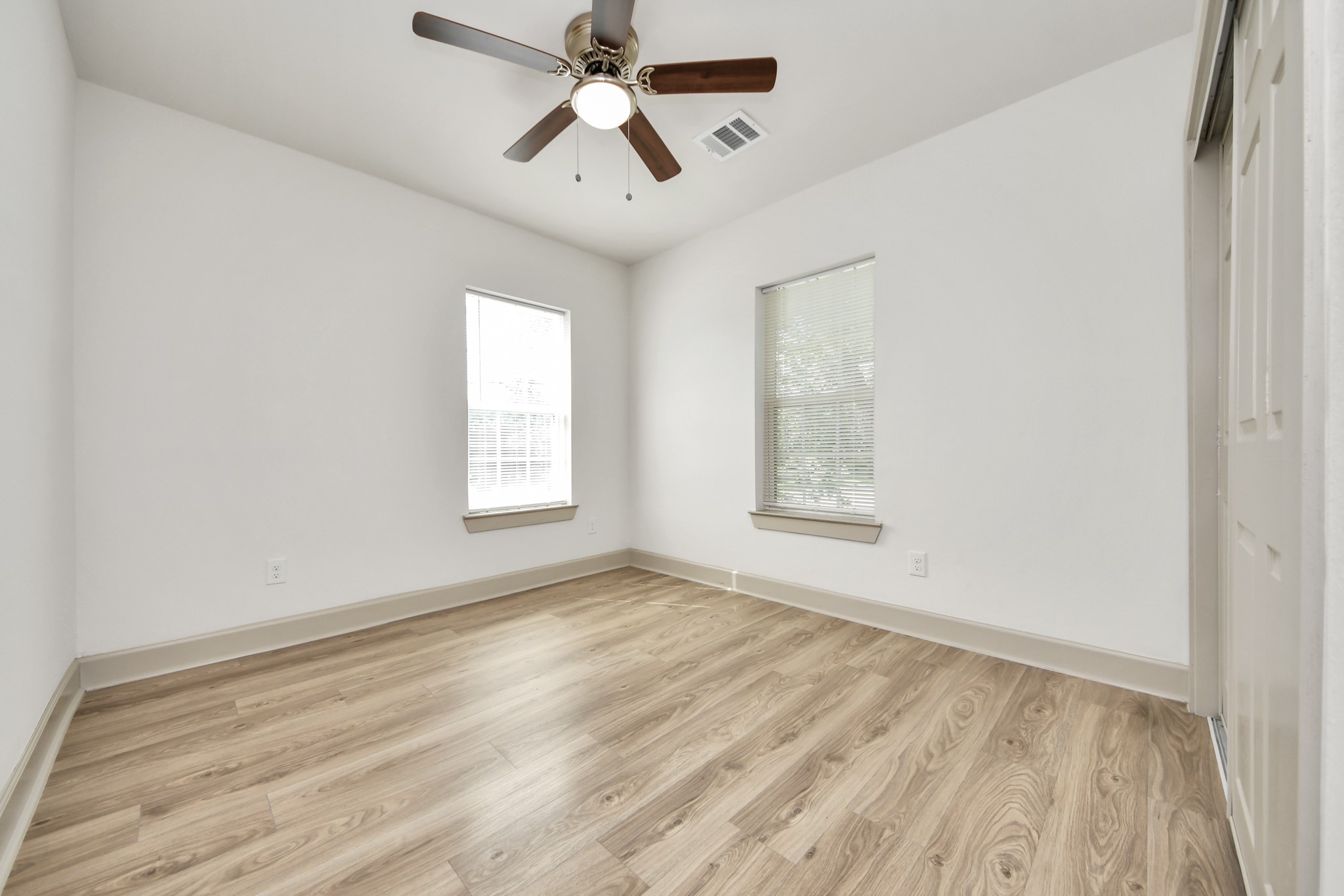 2919 Rosedale Street, Unit B Houston, TX 77004 - Photo 18 of 35 wooden floor in an empty room with a window