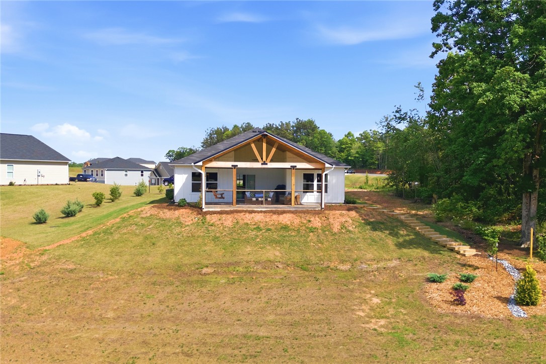 412 Chadwick Lane Walhalla, SC 29691 - Photo 24 of 37 This newly constructed residence showcases a welcoming rear patio with exposed timber framing, perfect for outdoor relaxation.