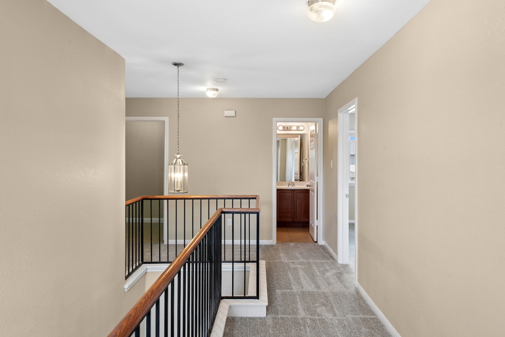458 Nottingham Loop Kyle, TX 78640 - Photo 19 of 38 a view of a hallway with wooden floor and staircase