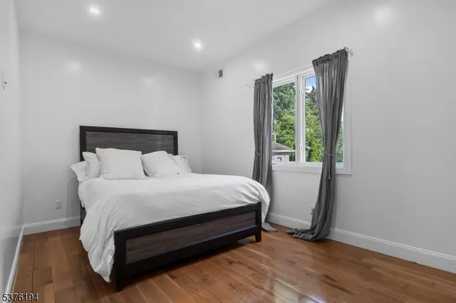 a bed sitting in a bedroom next to a window