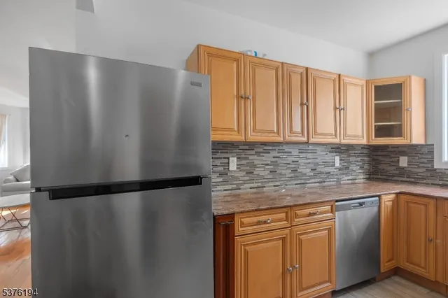 a kitchen with stainless steel appliances granite countertop white refrigerator a sink a stove and a microwave oven