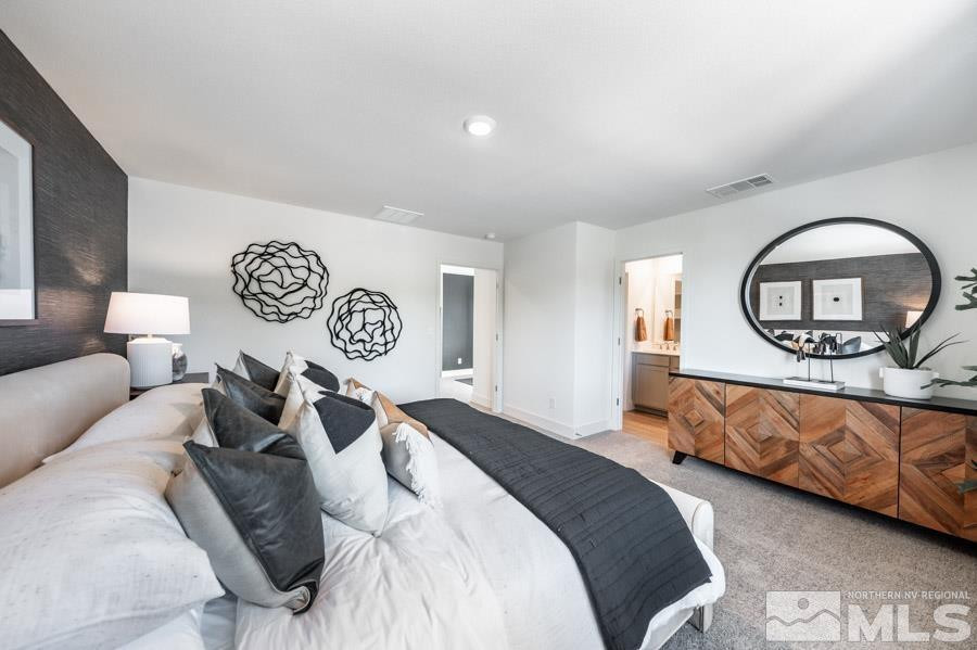 1621 Switchback Street, Unit LOT #25 Reno, NV 89523 - Photo 11 of 19 a bedroom with a bed and a large mirror on dresser
