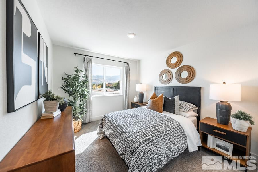 1621 Switchback Street, Unit LOT #25 Reno, NV 89523 - Photo 16 of 19 a bedroom with a bed and a chandelier