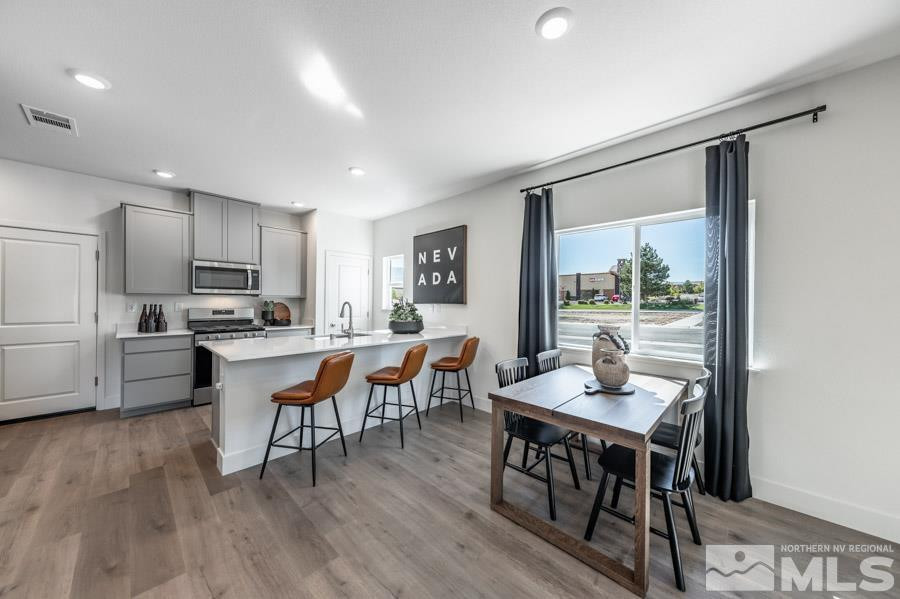 1621 Switchback Street, Unit LOT #25 Reno, NV 89523 - Photo 4 of 19 a kitchen with a dining table chairs and refrigerator