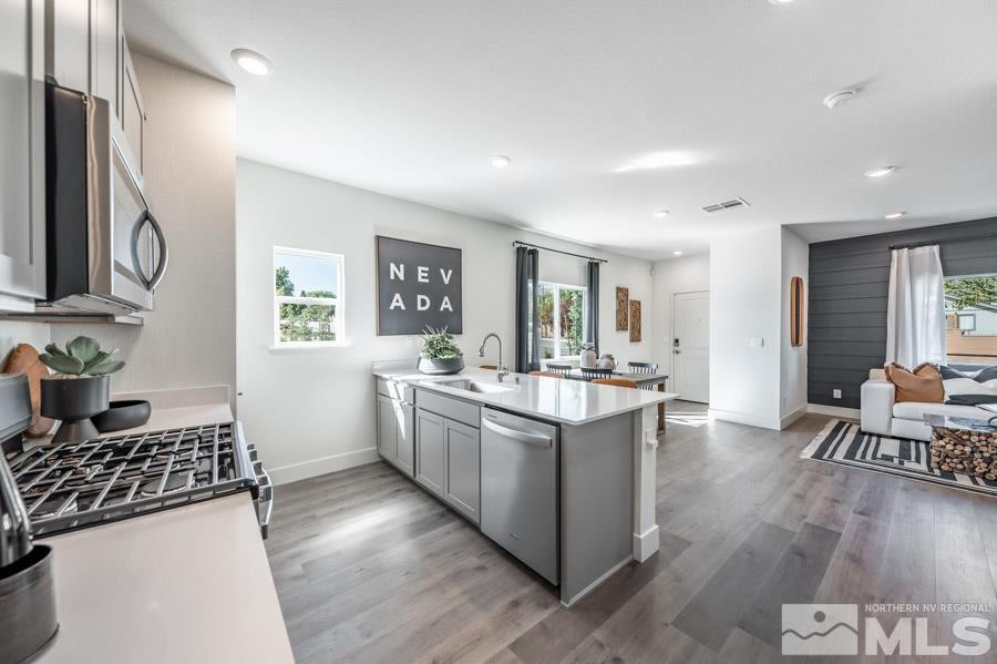 1621 Switchback Street, Unit LOT #25 Reno, NV 89523 - Photo 6 of 19 a kitchen with stainless steel appliances granite countertop a stove and a refrigerator