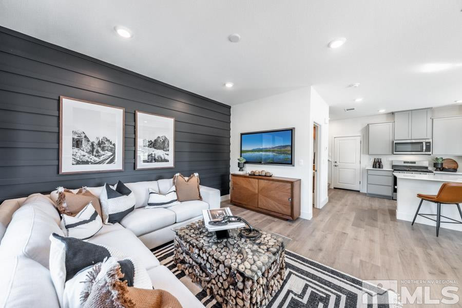 1621 Switchback Street, Unit LOT #25 Reno, NV 89523 - Photo 8 of 19 a living room with furniture and a flat screen tv