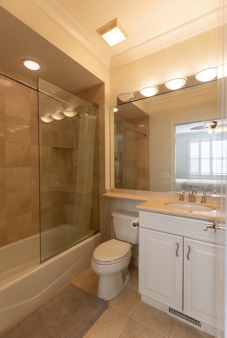 1125 West Monroe Street Chicago, IL 60607 - Photo 27 of 49 a bathroom with a granite countertop sink a toilet and shower