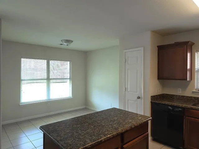 a kitchen with a stove and a window
