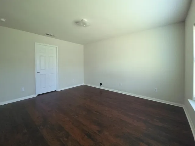 an empty room with wooden floor