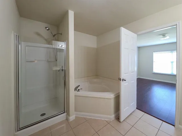 a bathroom with a shower and bathtub