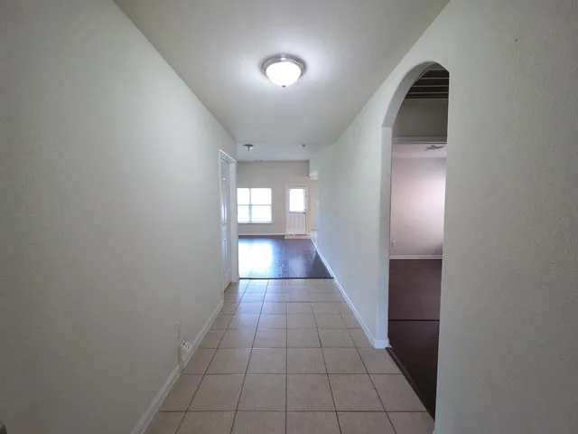 an entryway in a hall with a window